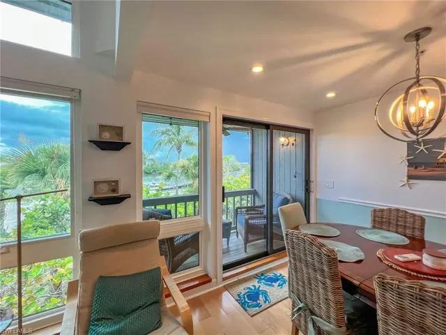 Dining space with hardwood / wood-style floors and a chandelier