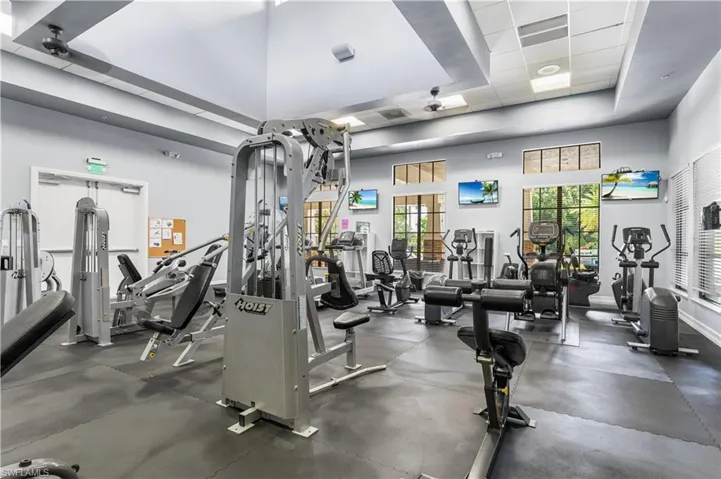 Workout area featuring a high ceiling and a raised ceiling