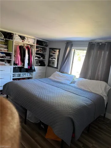 Bedroom with a closet and wood finished floors