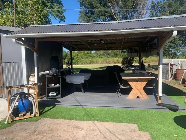 View of patio with ceiling fan and a deck