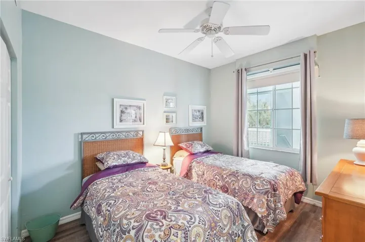 Bedroom with dark hardwood / wood-style flooring and ceiling fan