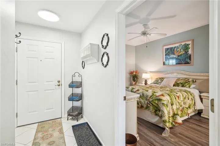 Bedroom with light tile patterned floors and ceiling fan