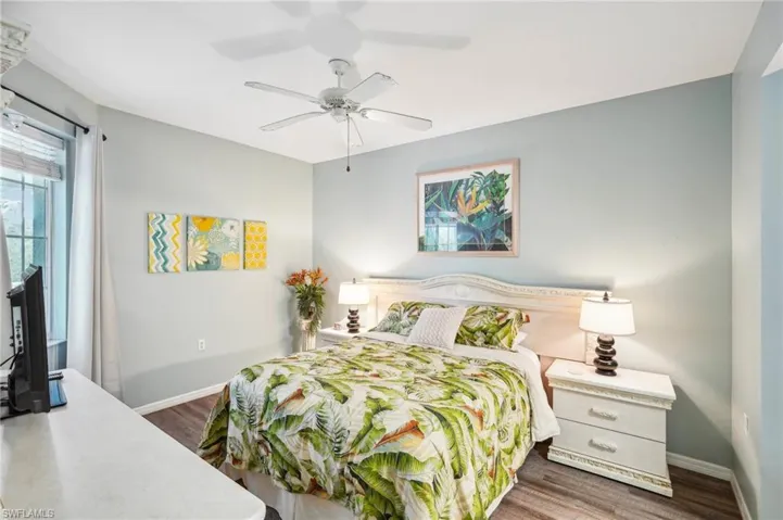 Bedroom featuring dark hardwood / wood-style floors and ceiling fan