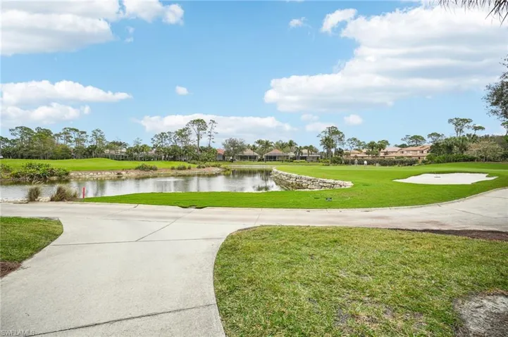 View of home's community featuring a water view and a lawn