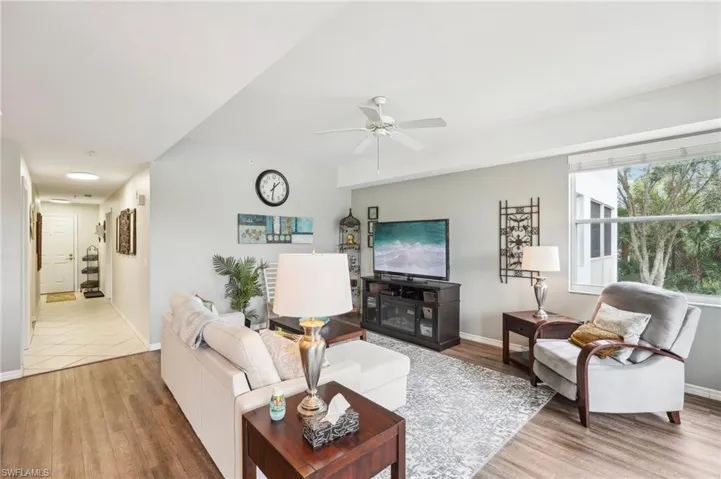 Living room featuring hardwood / wood-style flooring and ceiling fan