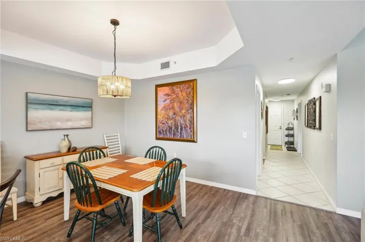 Dining space with a chandelier and light hardwood / wood-style flooring