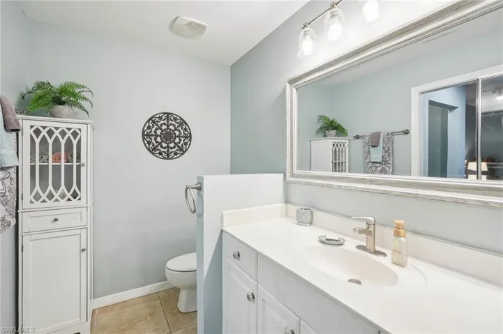 Bathroom featuring vanity, tile patterned floors, and toilet