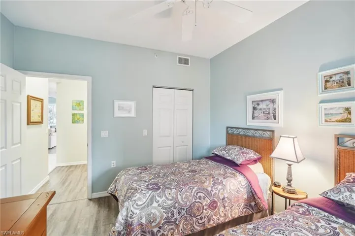 Bedroom featuring light wood-type flooring, ceiling fan, and a closet