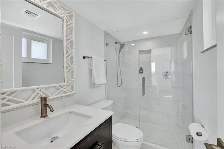 Full bathroom with vanity and a stall shower