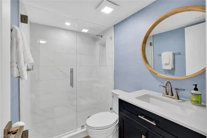 Bathroom featuring vanity and a shower stall