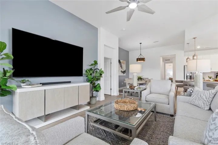Living room featuring dark hardwood / wood-style flooring and ceiling fan