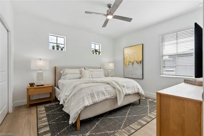 Bedroom with ceiling fan and light hardwood / wood-style flooring