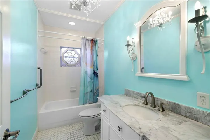 A tub / shower combo and stained glass