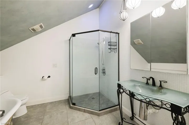 A unique glass vanity & easy access stand-up shower
