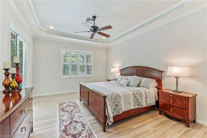 Main bedroom with a tray ceiling.