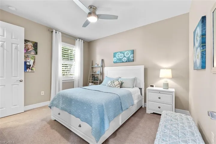 Bedroom 2 with walk-in closet with built in storage, and ceiling fan w/LED lighting