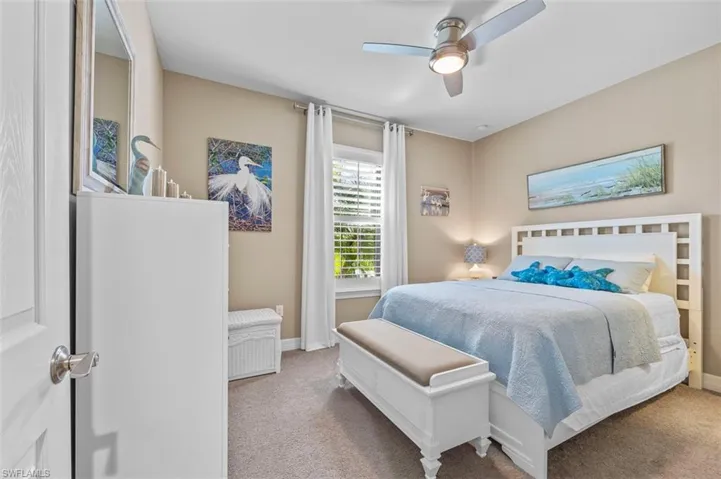 Bedroom 1 with walk-in closet with built in storage, and ceiling fan w/LED lighting