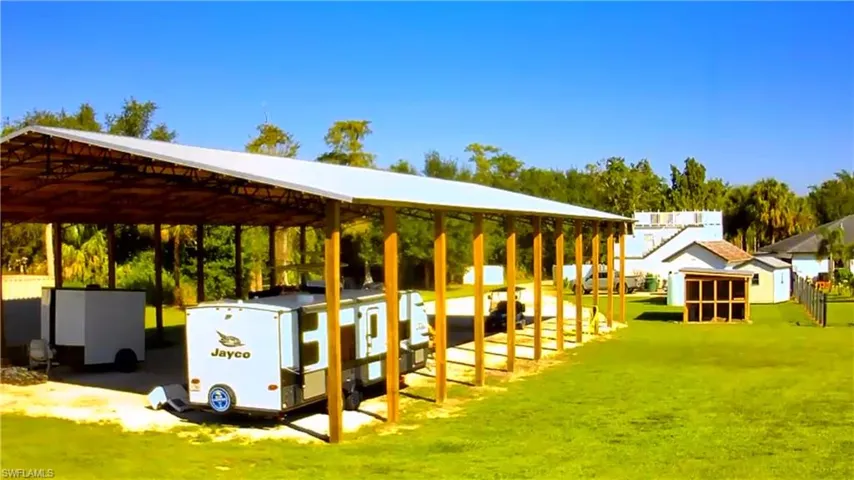 Surrounding community featuring a yard and a carport