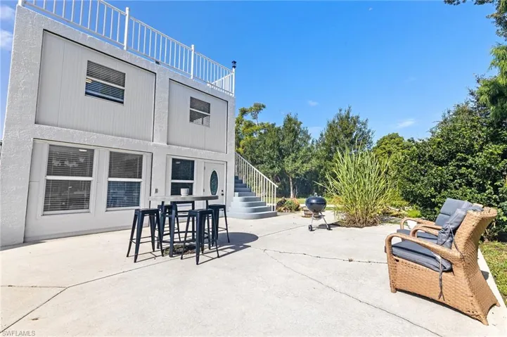 View of patio / terrace featuring outdoor dining area and stairway