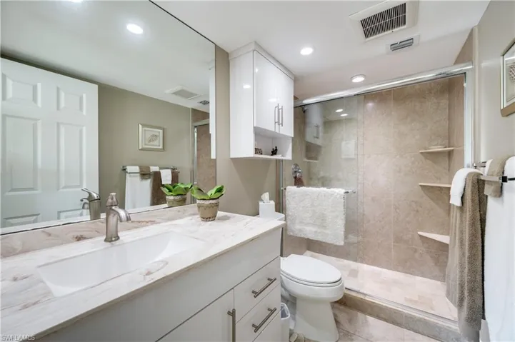 Full bath featuring a stall shower, vanity, and recessed lighting