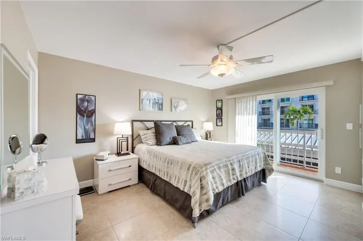 Bedroom with access to outside, a ceiling fan, and light tile patterned floors
