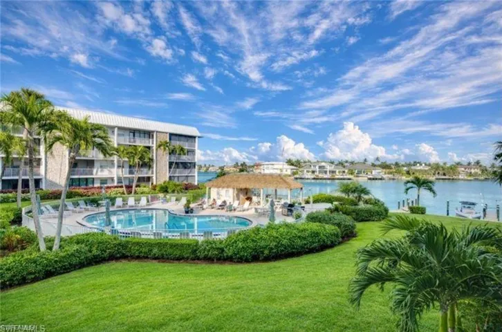 Community pool featuring a patio and a yard