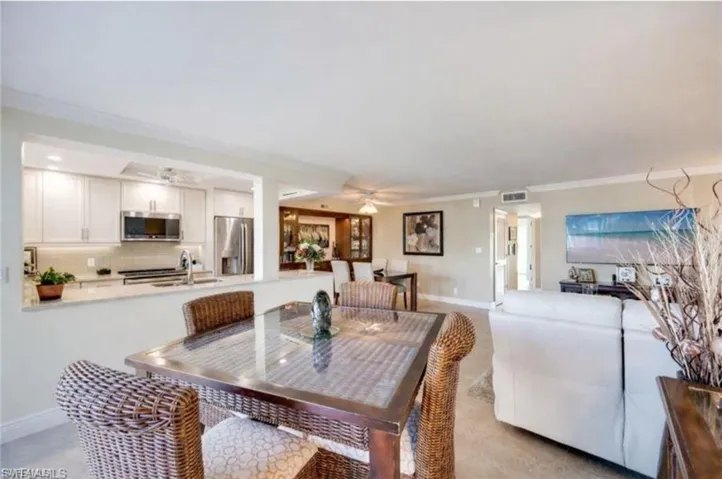 Dining space with a ceiling fan and ornamental molding
