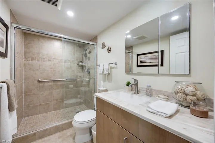 Full bathroom featuring vanity, a shower stall, and recessed lighting