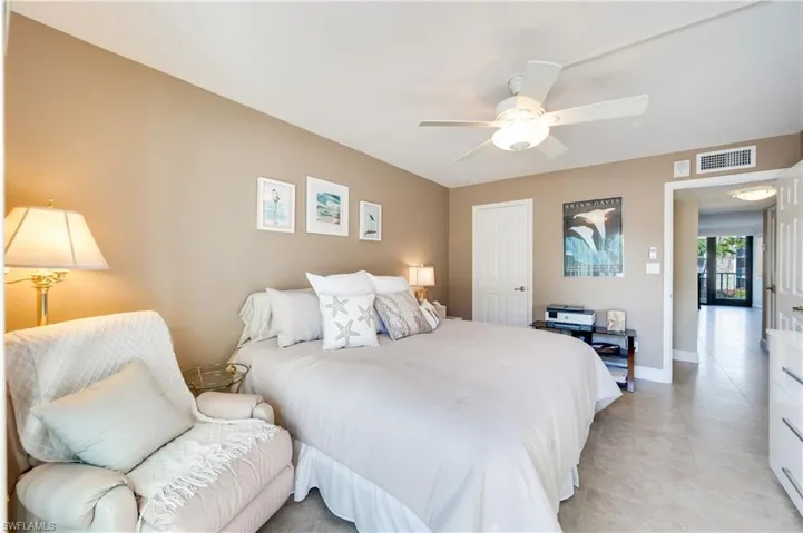 Bedroom with a ceiling fan and light tile patterned floors