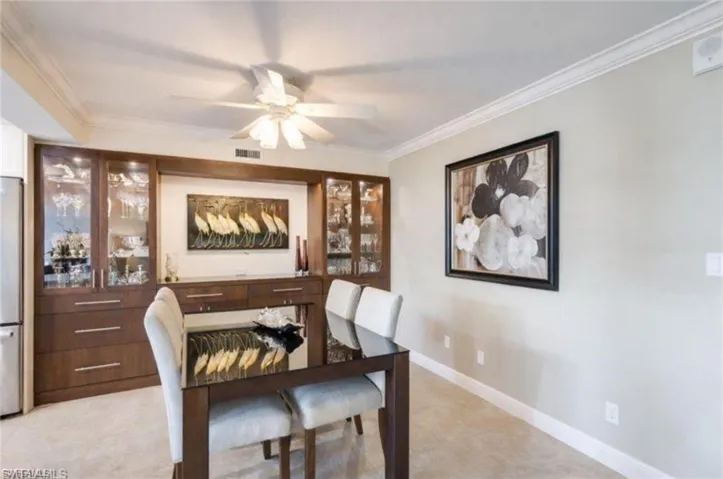 Dining room featuring ornamental molding and a ceiling fan