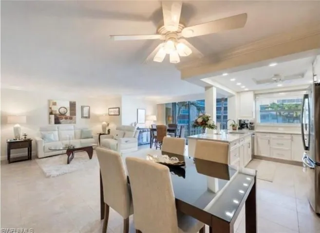 Dining room with light tile patterned floors, recessed lighting, and ornamental molding