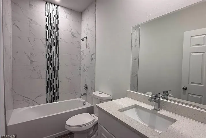 Bathroom featuring vanity and shower / tub combination