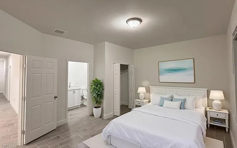 Bedroom featuring a closet, wood tiled floors, and connected bathroom