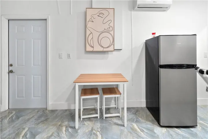 Detailed view of freestanding refrigerator and a wall mounted mini split