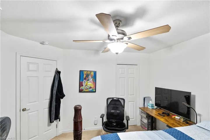 Bedroom with a ceiling fan and a closet