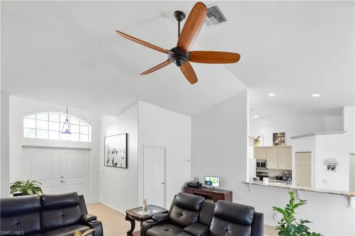 Living room featuring lofted ceiling and a ceiling fan
