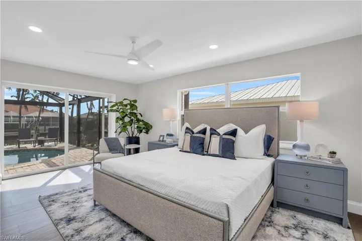 Primary bedroom with the greatest of views of the pool/lanai area.  So much natural light!