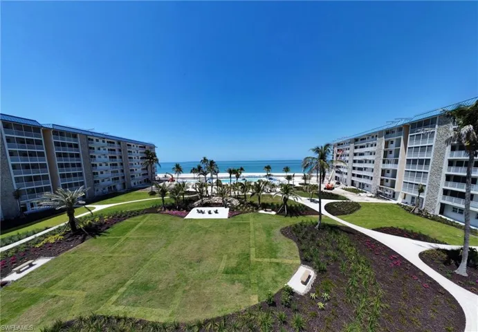 View of home's community with a lawn and a water view