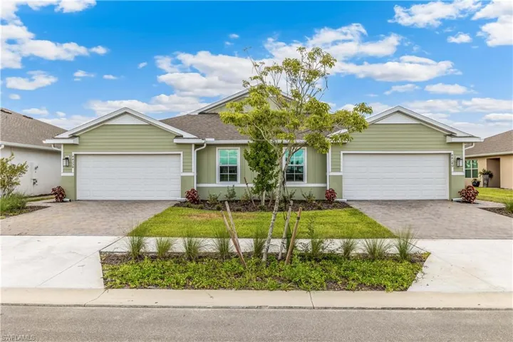 Ranch-style house featuring driveway and a front yard