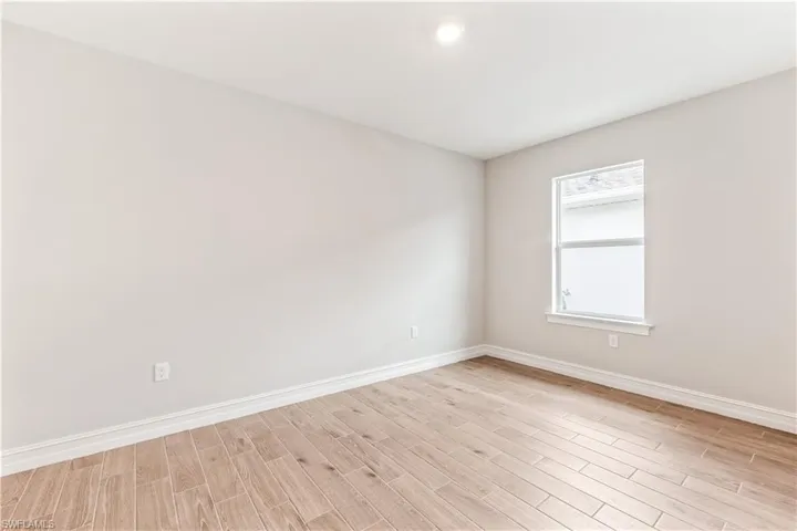 Spare room featuring baseboards and light wood-style flooring