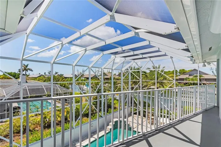 View of patio / terrace with an outdoor pool, a lanai, and a sunroom