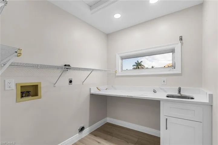 Laundry room featuring light wood-style floors, hookup for an electric dryer, and washer hookup