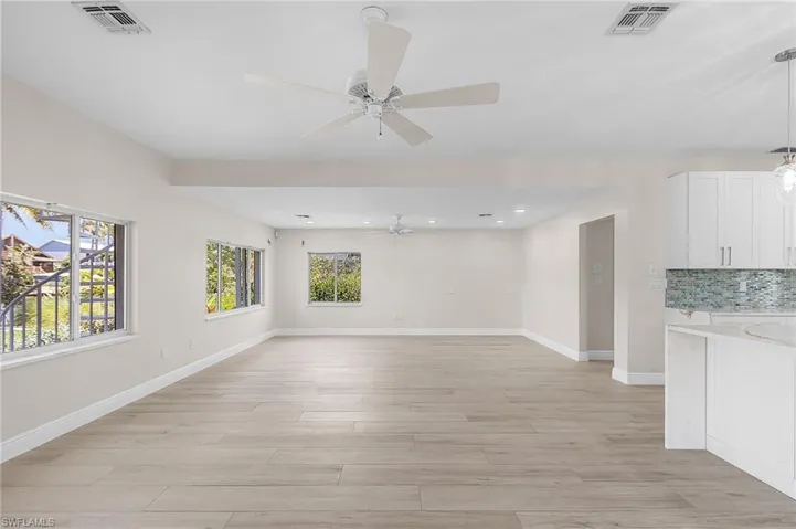 Family room featuring light wood-type flooring, plenty of natural light, ceiling fan, and recessed lighting