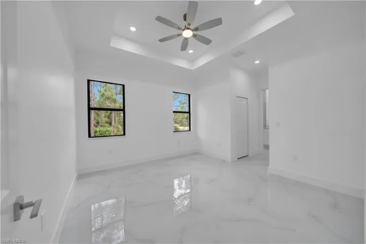 ceiling, light marble finish floors, recessed lighting, and a ceiling fan