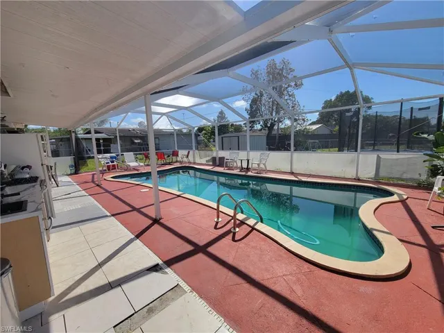 View of swimming pool featuring a shed, a patio area, a fenced backyard, an outbuilding, and a fenced in pool