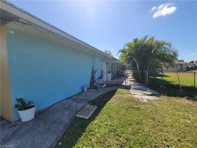 View of yard featuring fence and a gate