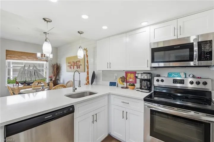 UPDATED KITCHEN...RECESSED AND CUSTOM LIGHTING...QUARTZ COUNTERTOPS...SS APPLIANCES