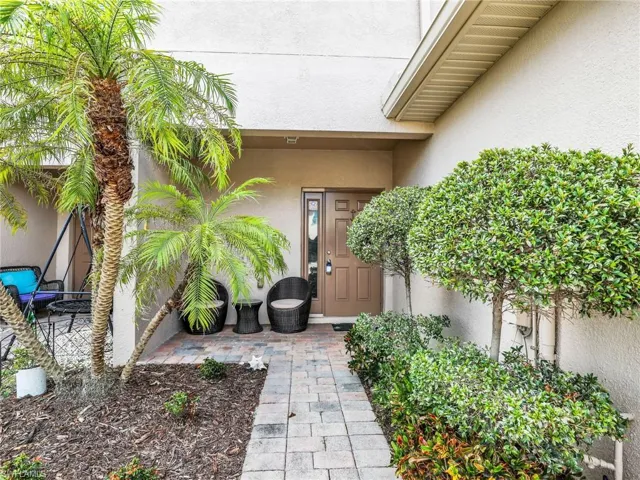 Frond Door with covered seating area and pavers walkway