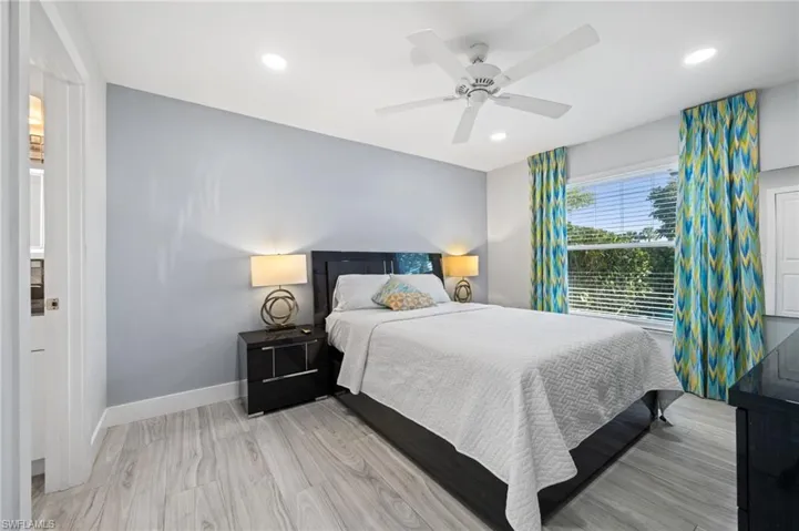 Bedroom featuring light wood-style floors, a ceiling fan, and recessed lighting