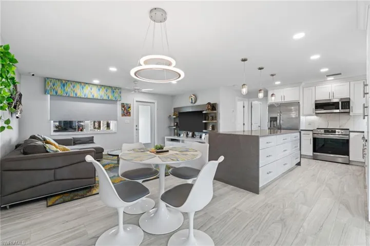 Dining room with recessed lighting, light wood finished floors, and ceiling fan
